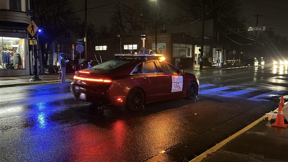 Instrumented test vehicle on wet night street